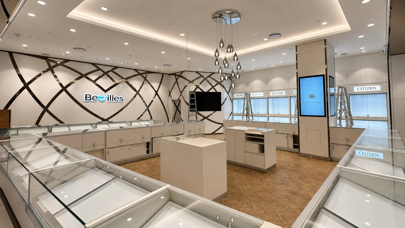 Bevilles jewellery store interior with freshly painted white walls, glass display cases, metallic wall detailing and ladders, with visible signs reading Bevilles, Seiko, AX Armani Exchange, Guess and Citizen.
