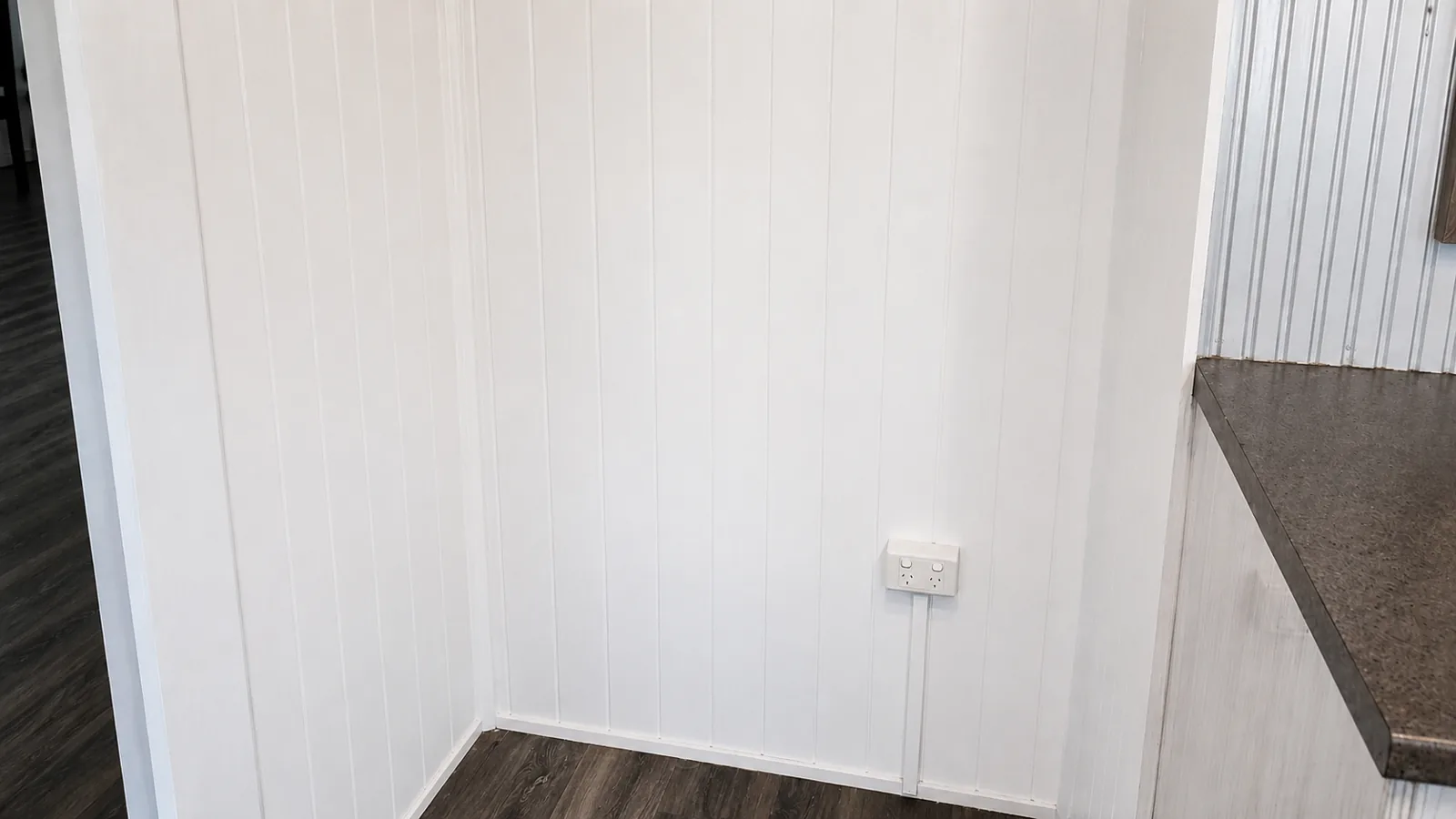 After, the same interior VJ wall panelling repainted by Paint Gods in a clean, even white finish.